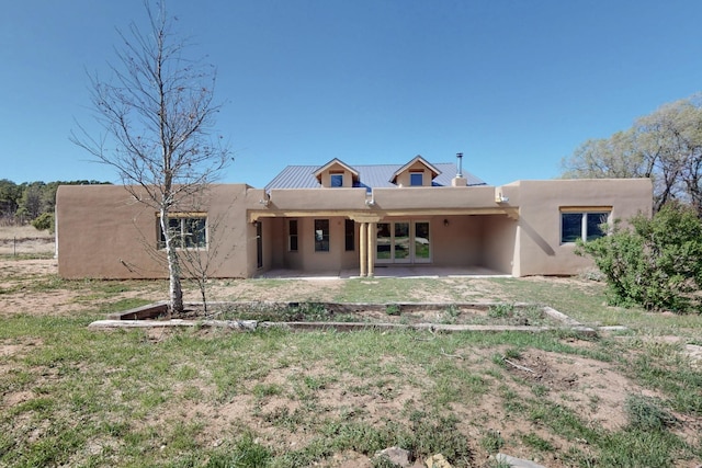 488 Old Denver Hwy, Glorieta, NM 87535 - back of house with stucco siding, a patio area, metal roof, and french doors