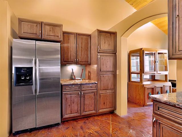 488 Old Denver Hwy, Glorieta, NM 87535 - kitchen featuring stainless steel fridge, arched walkways, and light stone counters