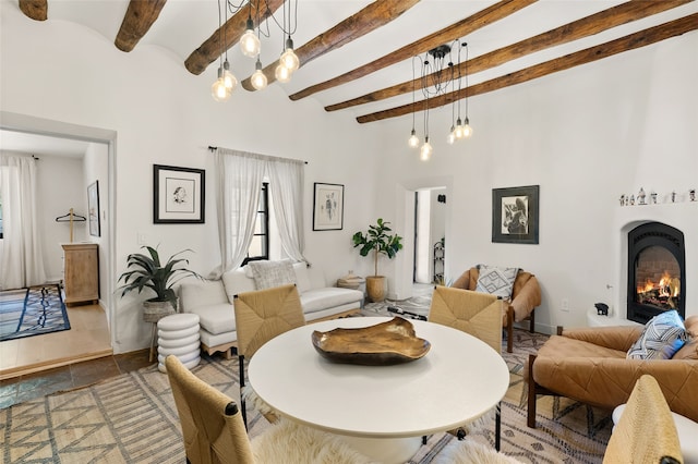 824 Dunlap St Unit A, Santa Fe, NM 87501 - living area with beamed ceiling, a fireplace, and a towering ceiling