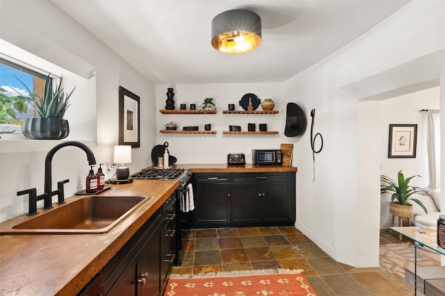 824 Dunlap St Unit A, Santa Fe, NM 87501 - indoor wet bar featuring stainless steel gas range oven, dark stone finish flooring, baseboards, and black microwave