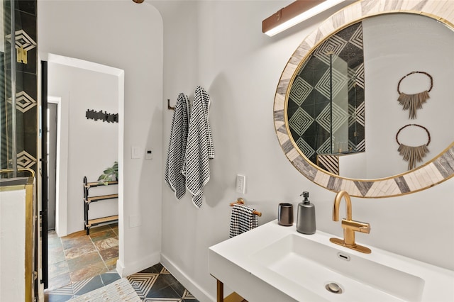 824 Dunlap St Unit A, Santa Fe, NM 87501 - bathroom featuring a sink, baseboards, and stone tile floors