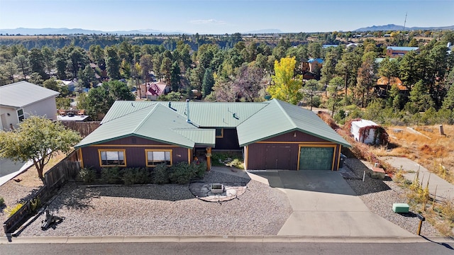 1043 Cheyenne, Los Alamos, NM 87544 - view of front of property featuring metal roof, a mountain view, a detached garage, and driveway