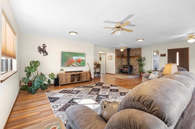 1043 Cheyenne, Los Alamos, NM 87544 - living area featuring a ceiling fan, a wood stove, and wood finished floors
