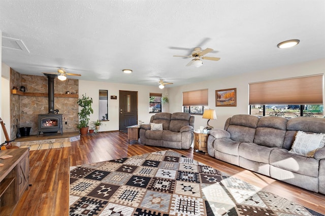 1043 Cheyenne, Los Alamos, NM 87544 - living area with wood finished floors, ceiling fan, a wood stove, and a textured ceiling