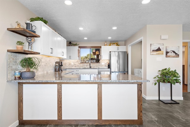 1043 Cheyenne, Los Alamos, NM 87544 - kitchen with stainless steel appliances, open shelves, light stone counters, a peninsula, and white cabinets