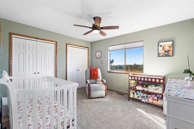 1043 Cheyenne, Los Alamos, NM 87544 - carpeted bedroom featuring multiple closets, a nursery area, baseboards, and ceiling fan