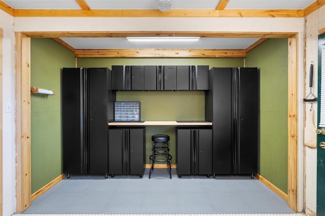 1043 Cheyenne, Los Alamos, NM 87544 - kitchen featuring freestanding refrigerator, baseboards, light floors, and dark cabinets