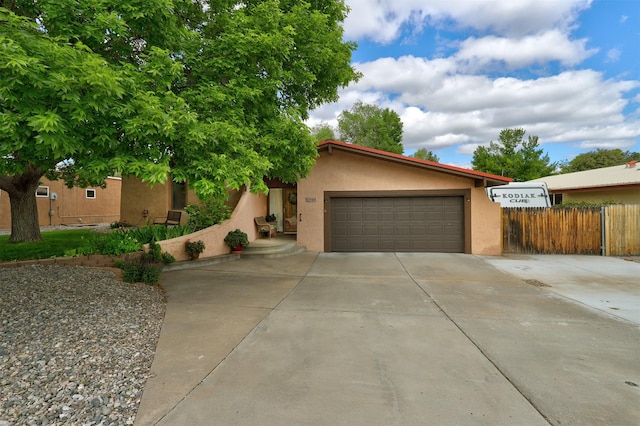 444 Aragon, White Rock, NM 87547 - view of front of house with stucco siding, driveway, and a garage