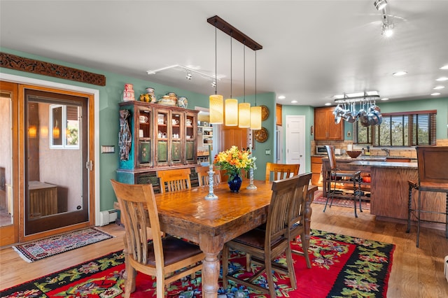 1007 Calle Largo, Santa Fe, NM 87501 - dining room featuring a baseboard heating unit, light wood finished floors, and recessed lighting