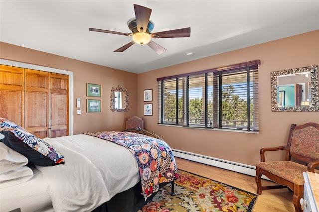 1007 Calle Largo, Santa Fe, NM 87501 - bedroom with a baseboard radiator, wood finished floors, and ceiling fan