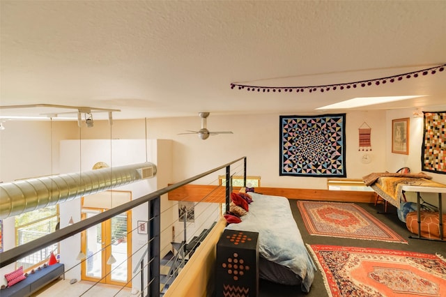 3600 Cerrillos Unit 208, Santa Fe, NM 87507 - hall featuring an upstairs landing and a textured ceiling