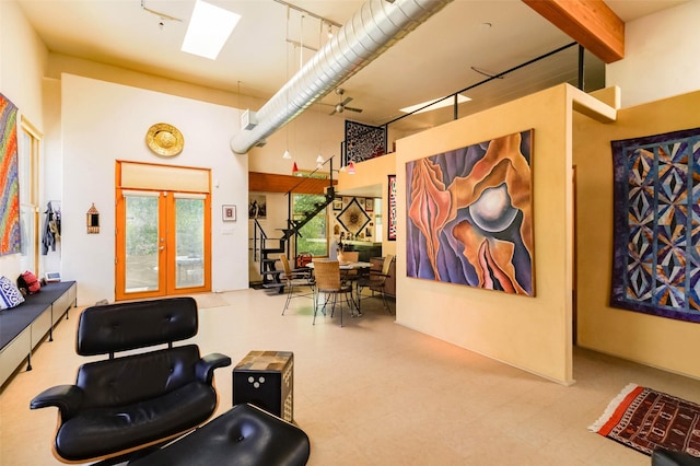 3600 Cerrillos Unit 208, Santa Fe, NM 87507 - living area featuring a towering ceiling, a skylight, tile patterned floors, and french doors