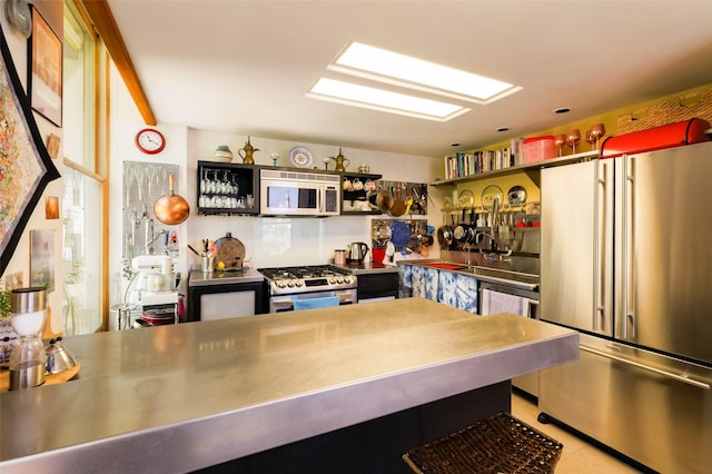 3600 Cerrillos Unit 208, Santa Fe, NM 87507 - kitchen featuring stainless steel counters, stainless steel appliances, light tile patterned floors, and open shelves