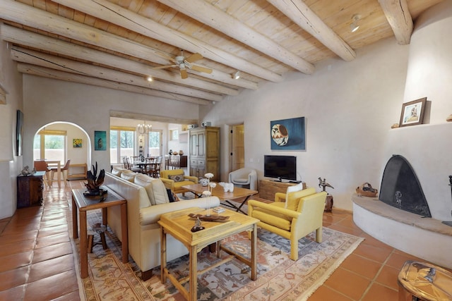 425 Calle Kokopelli, Santa Fe, NM 87501 - living area with tile patterned flooring, wooden ceiling with exposed beams, arched walkways, a ceiling fan, and a chandelier