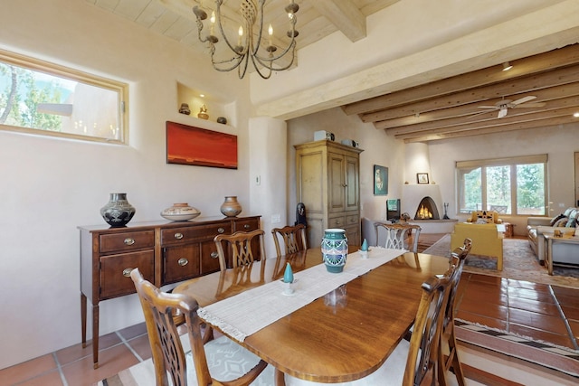 425 Calle Kokopelli, Santa Fe, NM 87501 - dining space with beam ceiling, a chandelier, tile patterned flooring, and a fireplace