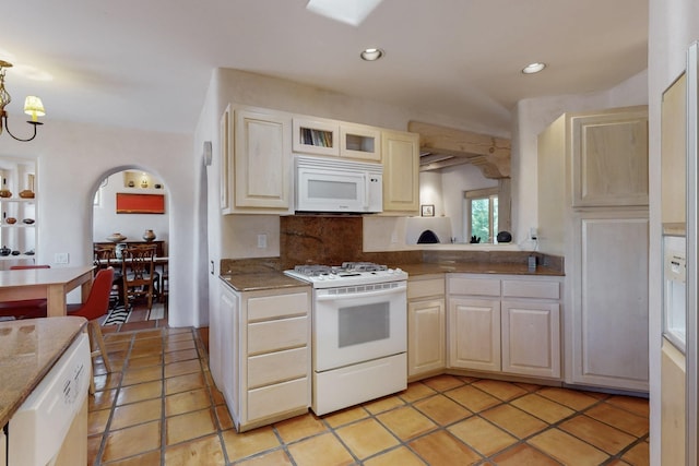 425 Calle Kokopelli, Santa Fe, NM 87501 - kitchen with white appliances, arched walkways, backsplash, recessed lighting, and light tile patterned floors