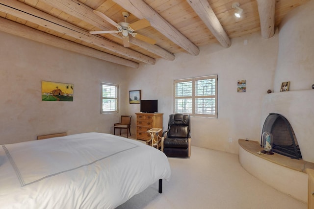 425 Calle Kokopelli, Santa Fe, NM 87501 - bedroom featuring wooden ceiling with exposed beams, carpet flooring, and a ceiling fan
