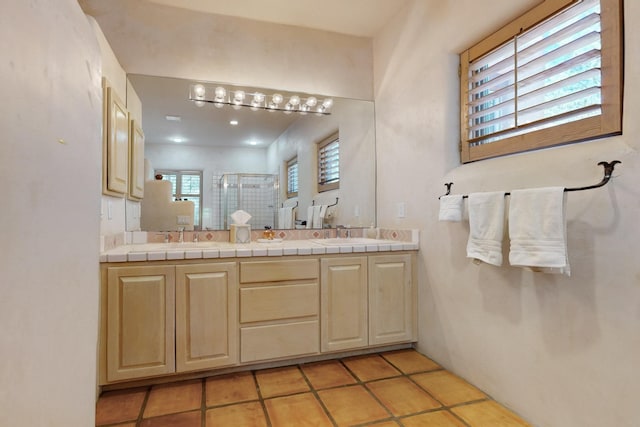 425 Calle Kokopelli, Santa Fe, NM 87501 - bathroom featuring a shower stall, double vanity, and tile patterned floors