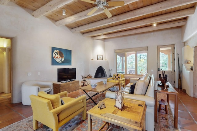 425 Calle Kokopelli, Santa Fe, NM 87501 - living area with wooden ceiling with exposed beams, a large fireplace, tile patterned flooring, and ceiling fan