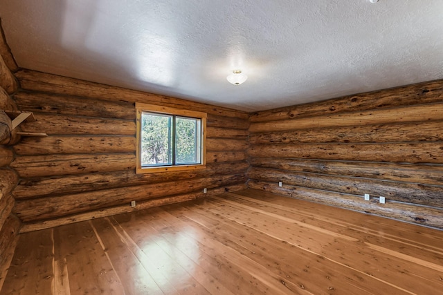 76 Los Altos De Cicuye, Pecos, NM 87552 - unfurnished room featuring hardwood / wood-style floors and a textured ceiling