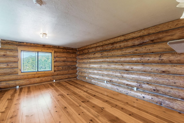 76 Los Altos De Cicuye, Pecos, NM 87552 - unfurnished room featuring hardwood / wood-style floors, a textured ceiling, and a smoke detector