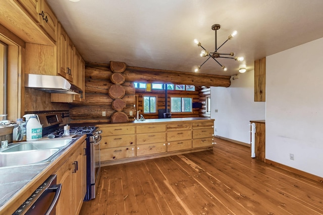 76 Los Altos De Cicuye, Pecos, NM 87552 - kitchen with log walls, under cabinet range hood, dark wood-style flooring, a chandelier, and gas stove