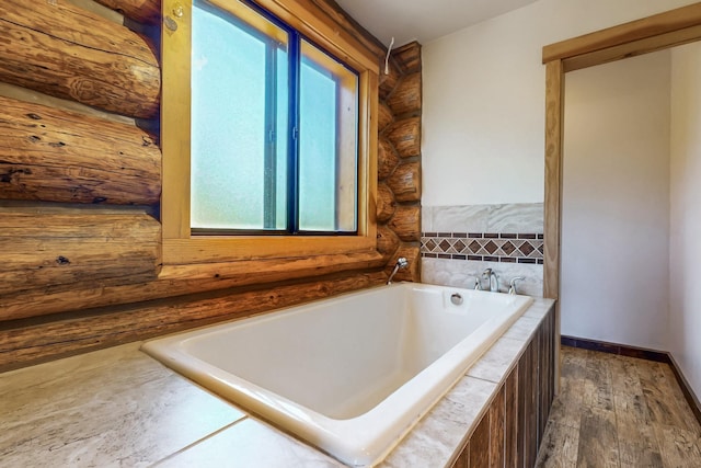 76 Los Altos De Cicuye, Pecos, NM 87552 - full bath featuring log walls, a garden tub, and wood finished floors