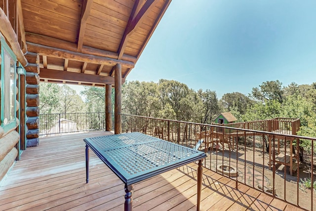 76 Los Altos De Cicuye, Pecos, NM 87552 - wooden terrace with a playground and view of scattered trees