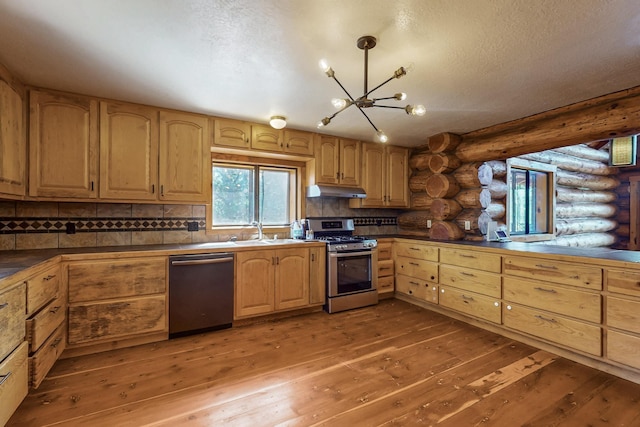 76 Los Altos De Cicuye, Pecos, NM 87552 - kitchen with stainless steel appliances, rustic walls, a chandelier, light wood-style flooring, and a sink