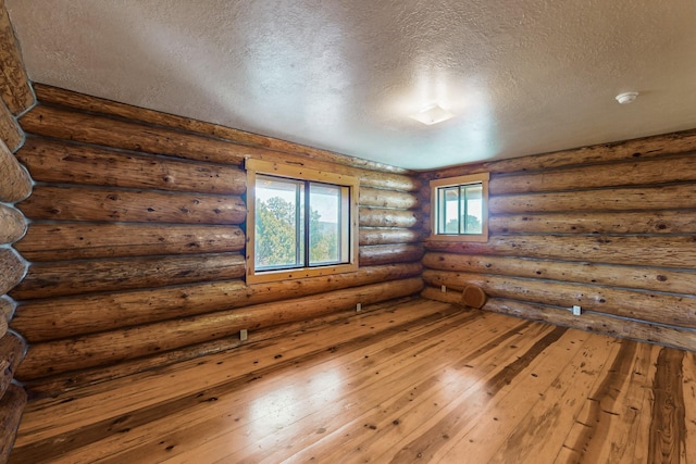 76 Los Altos De Cicuye, Pecos, NM 87552 - spare room featuring a textured ceiling and wood-type flooring