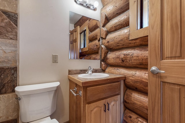 76 Los Altos De Cicuye, Pecos, NM 87552 - half bath with log walls, vanity, and toilet