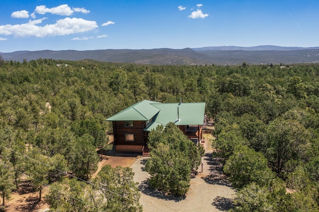 76 Los Altos De Cicuye, Pecos, NM 87552 - view of subject property featuring a heavily wooded area and a mountain backdrop