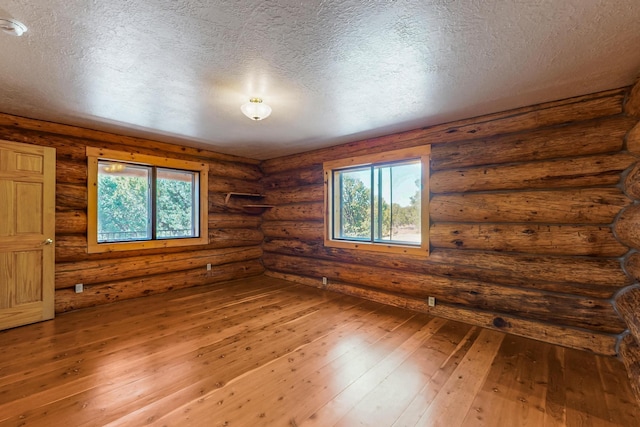 76 Los Altos De Cicuye, Pecos, NM 87552 - spare room featuring wood-type flooring and a textured ceiling