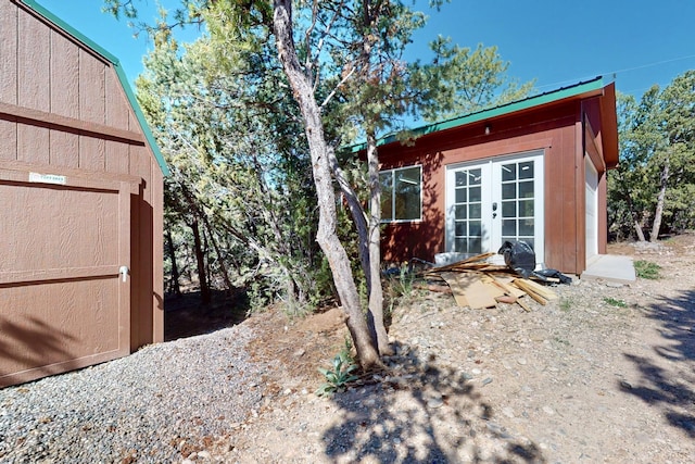 76 Los Altos De Cicuye, Pecos, NM 87552 - view of property exterior featuring french doors and an outbuilding