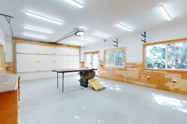 76 Los Altos De Cicuye, Pecos, NM 87552 - garage with wood walls and a garage door opener