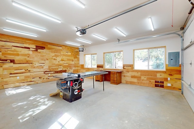 76 Los Altos De Cicuye, Pecos, NM 87552 - garage featuring wood walls, electric panel, and a garage door opener