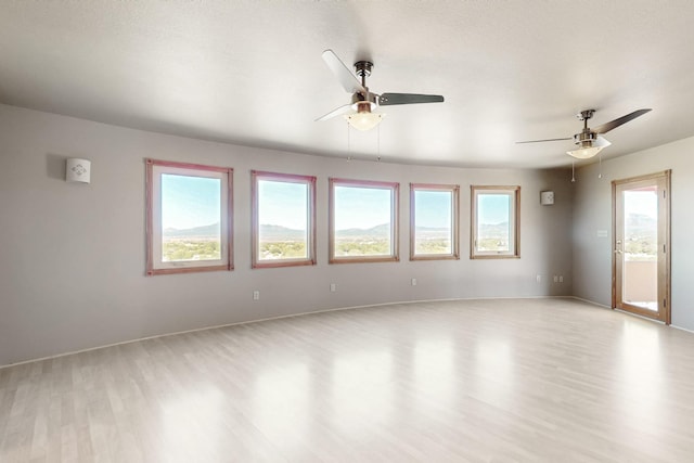 5 La Aguapa, Sandia Park, NM 87047 - spare room with light wood-type flooring, ceiling fan, and baseboards