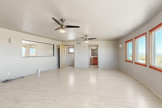 5 La Aguapa, Sandia Park, NM 87047 - unfurnished living room with light wood-type flooring, a ceiling fan, plenty of natural light, and baseboards
