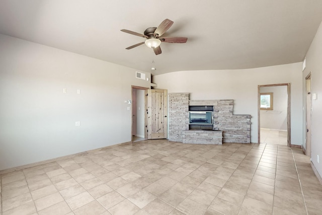 5 La Aguapa, Sandia Park, NM 87047 - unfurnished living room featuring ceiling fan, light tile patterned floors, a fireplace, and baseboards
