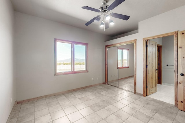 5 La Aguapa, Sandia Park, NM 87047 - unfurnished bedroom with a closet, ceiling fan, baseboards, and light tile patterned flooring
