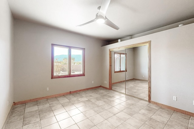 5 La Aguapa, Sandia Park, NM 87047 - unfurnished bedroom featuring a closet, a ceiling fan, light tile patterned floors, and baseboards