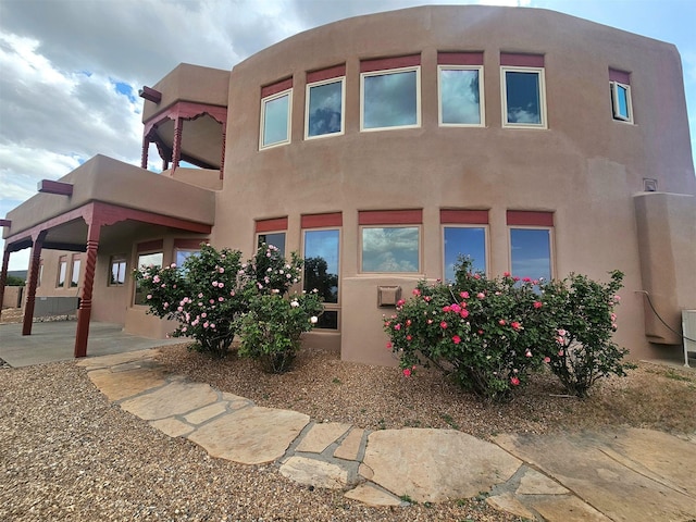 5 La Aguapa, Sandia Park, NM 87047 - rear view of house featuring stucco siding