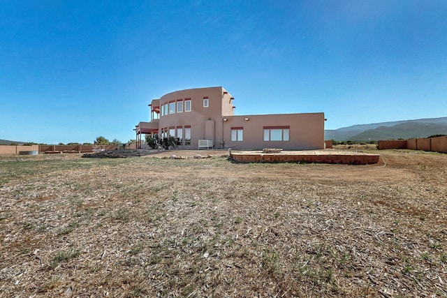 5 La Aguapa, Sandia Park, NM 87047 - back of property with stucco siding, central air condition unit, and a mountain view
