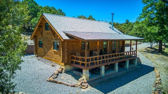 17 Bobcat Ln, Los Ojos, NM 87551 - back of property featuring log exterior, a shingled roof, and a deck