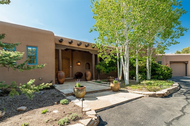 1050 Sierra Del Norte, Santa Fe, NM 87501 - view of front of property with an attached garage