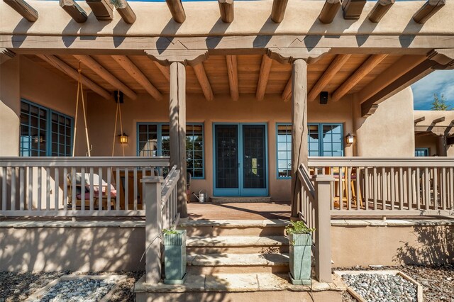 1050 Sierra Del Norte, Santa Fe, NM 87501 - view of exterior entry with stucco siding and covered porch