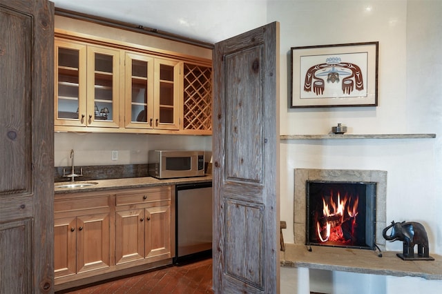 1050 Sierra Del Norte, Santa Fe, NM 87501 - bar featuring stainless steel microwave, a sink, fridge, brick flooring, and a high end fireplace