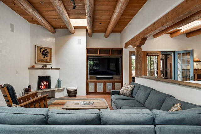 1050 Sierra Del Norte, Santa Fe, NM 87501 - living area featuring wood ceiling with exposed beams, a fireplace, wood finished floors, and decorative columns