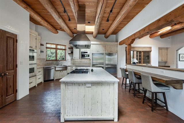 1050 Sierra Del Norte, Santa Fe, NM 87501 - kitchen featuring wooden ceiling with exposed beams, stainless steel appliances, brick floors, a sink, and tasteful backsplash