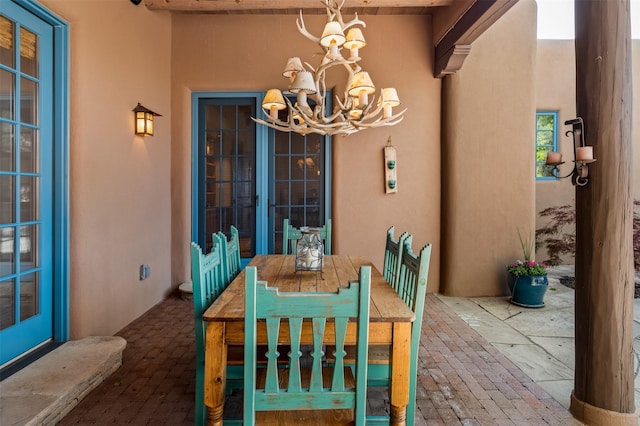 1050 Sierra Del Norte, Santa Fe, NM 87501 - dining area featuring a chandelier and brick flooring